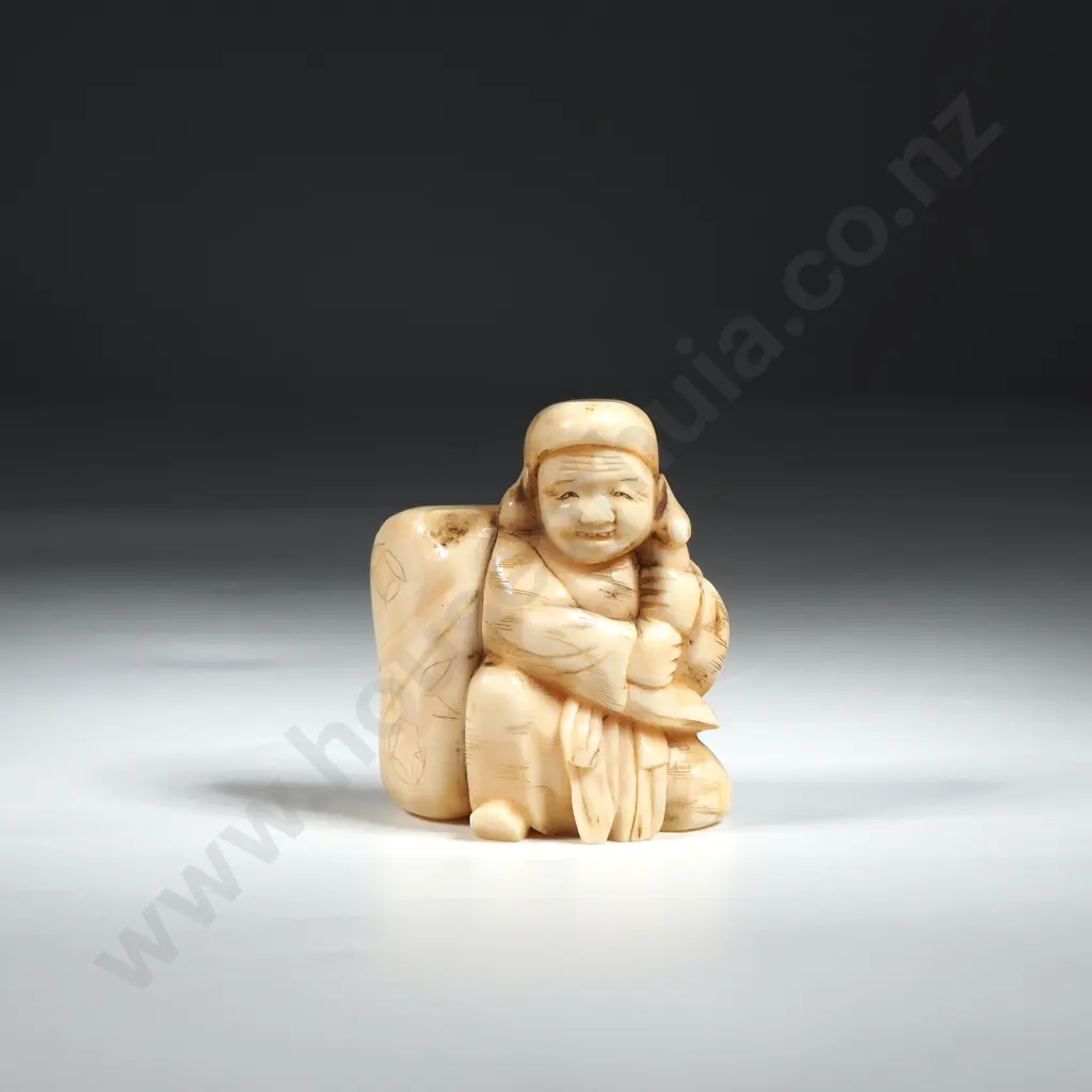 Ivory Okimono Depicting a Man with Sack & Holding a Rod Image 1++