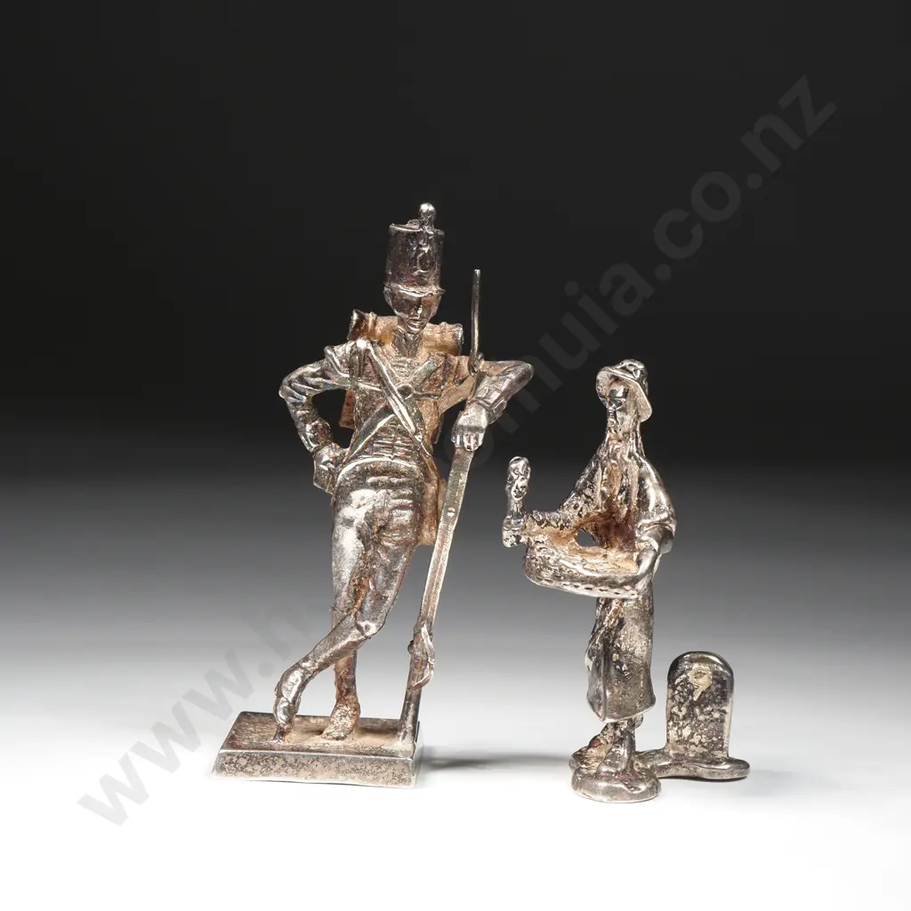 Two Figurines: A Silver Toy Solder & a Street Seller w Milestone Image 1++