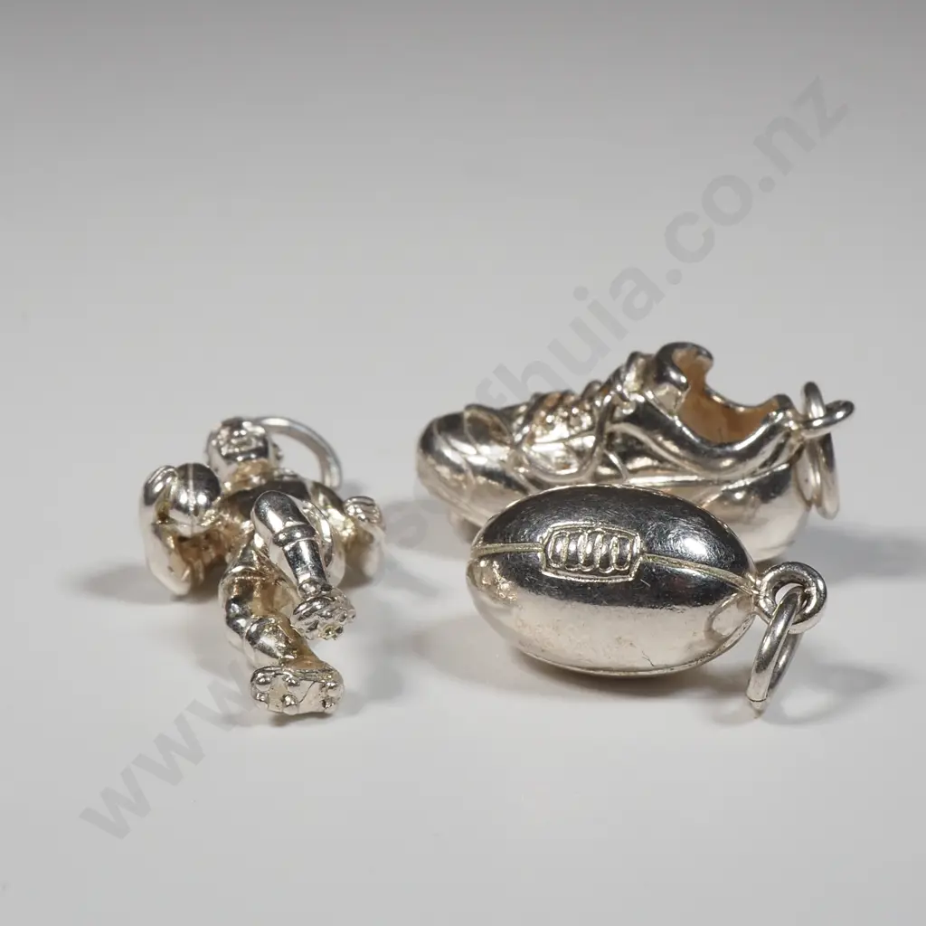 Three Sterling Silver Rugby Charms Including A Rugby Ball, Rugby Player & A Rugby Boot Image 1++
