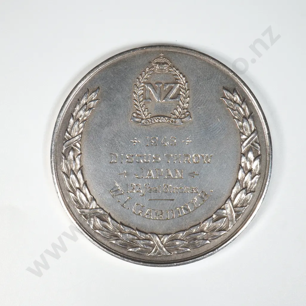 Sterling silver prize medal struck for 2nd New Zealand Expeditionary Force. Engraved “1946 / DISCUS THROW / JAPAN / 122 FEET 8 INCHES / W. I. GARDINER”. 47mm, 50.3 grams. It is listed in the Catalogue of New Zealand Commemorative Medals 1941-2007 by Hamish MacMaster as number 1944/1 and is very rare Image 1++