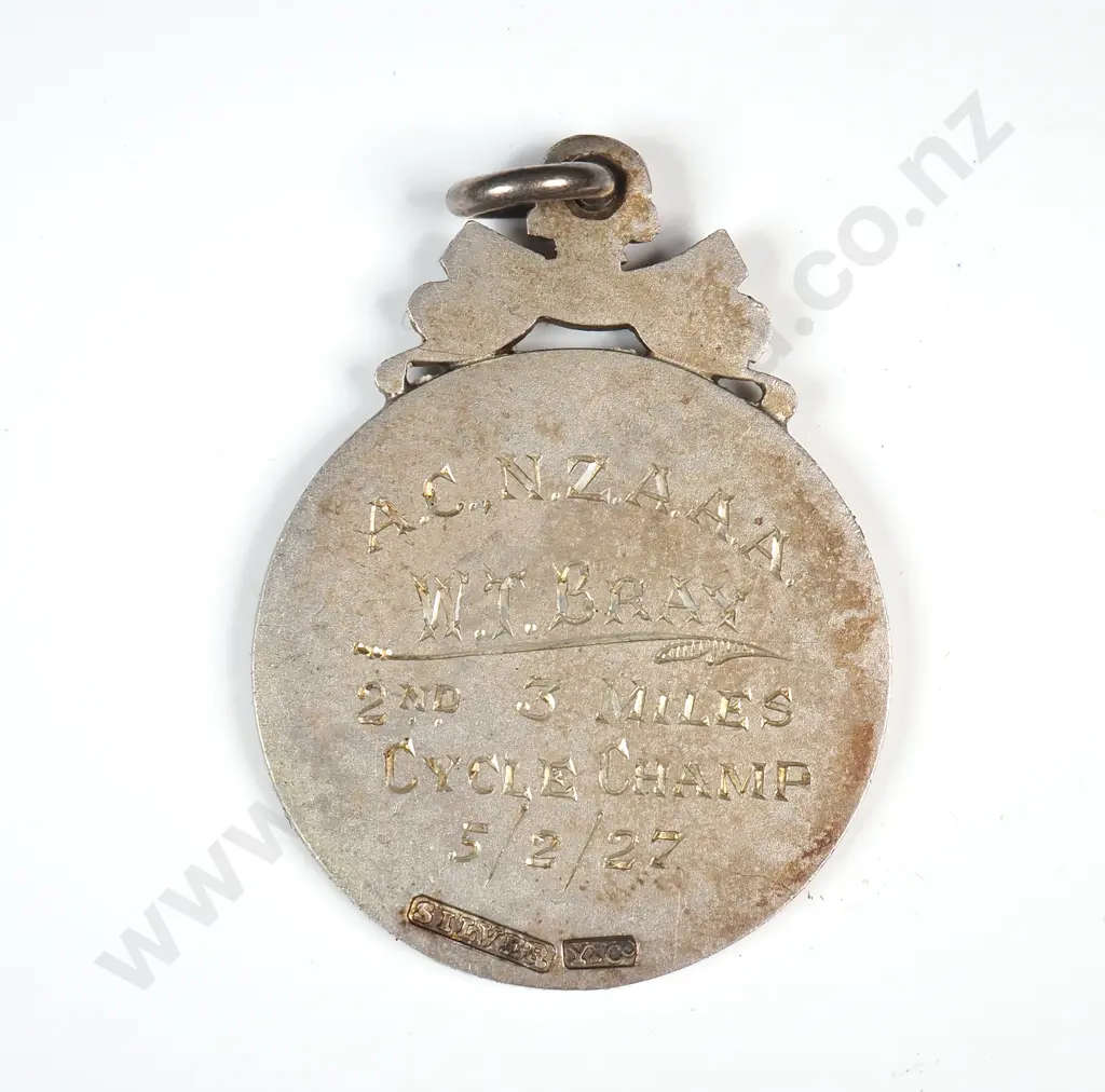 Sterling silver sports prize fob medal, runners on the front and “AUCKLAND”, the back engraved “A.C.N.Z.A.A.A. / W. T. BRAY / 2ND. 3 MILE / CYCLE CHAMP / 5/2/27”. Stamped “SILVER” and “Y&Co” ( Young and Co ) Image 1++