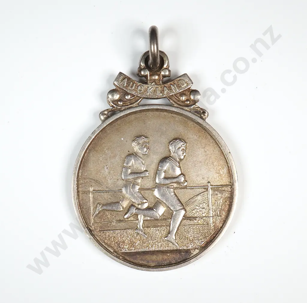 Sterling silver sports prize fob medal, runners on the front and “AUCKLAND”, the back engraved “A.C.N.Z.A.A.A. / W. T. BRAY / 2ND. 3 MILE / CYCLE CHAMP / 5/2/27”. Stamped “SILVER” and “Y&Co” ( Young and Co ) Image 1++