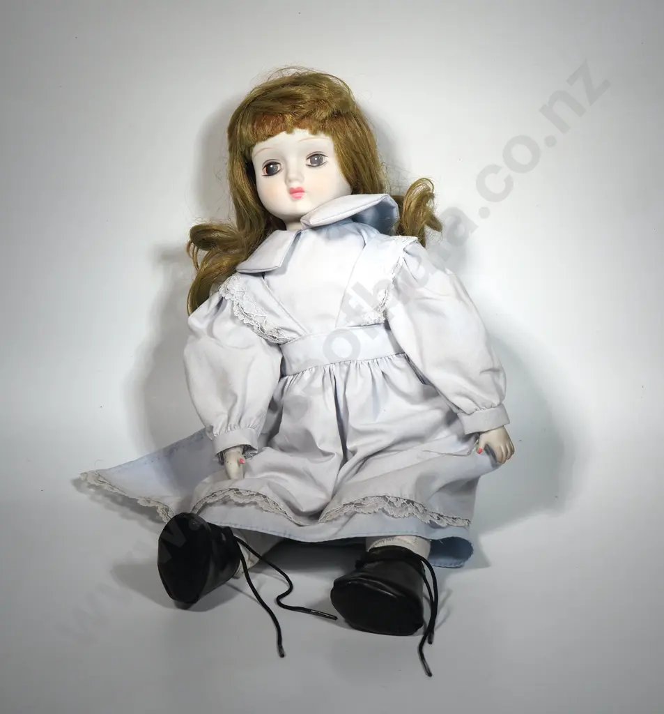 Vintage Porcelain Doll Featuring a Pale Blue Dress w White Lace Detailing Image 1++