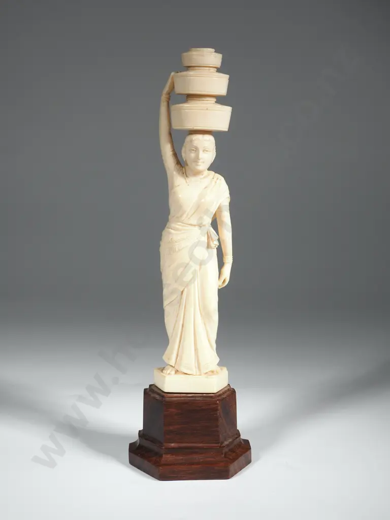 An Ivory Indian Carving of a Woman Carrying Three Baskets Above Head. Image 1++