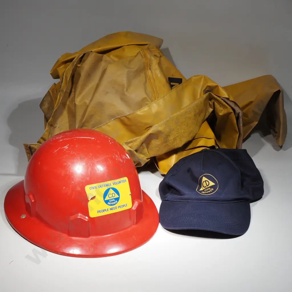 One Civil defence Red Helmet, Blue Cloth Cap and Yellow NZ Railways Rain Coat. Image 1++