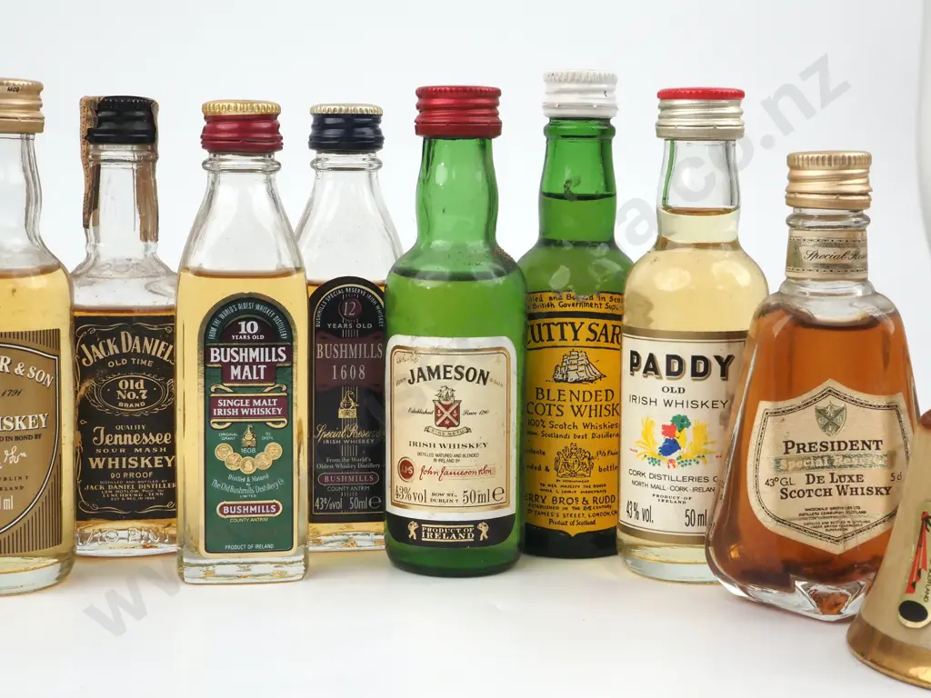 Quantity Of Miniature Whiskey/ Whisky Bottles Including a Miniature Wade Bells Scotch Whisky Decanter In A  Bell Shape Image 1++