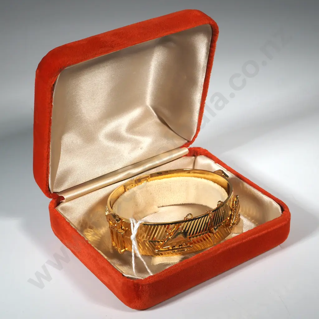 Cased Gold Coloured Snap Bangle w House/Sailboat Motif. Image 1++